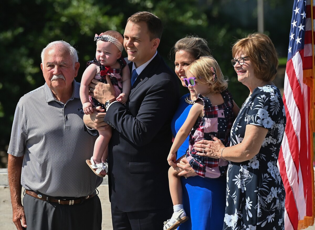 Capt. Michael K. Hole stands with his family after taking his oath of office.