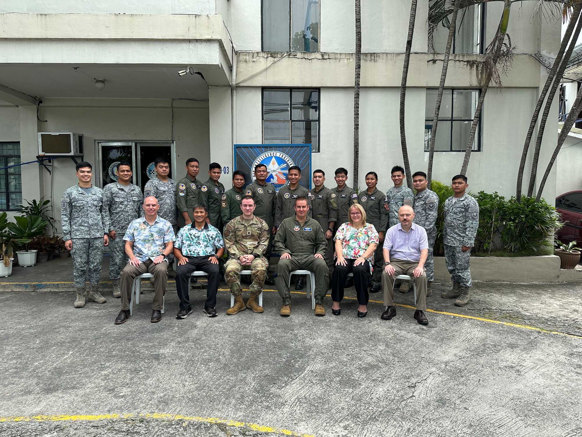 photo of a large group of U.S. Air Force military members and Philippine Air Force members standing in front of a building