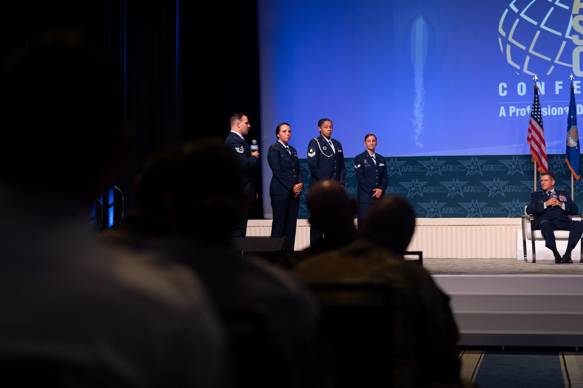 U.S. Air Force Brig. Gen. Christopher Amrhein, Air Force Recruiting Service commander, and U.S. Air Force Command Chief Master Sgt. Rebecca Arbona, Air Force Recruiting Service senior enlisted leader, listen to Airmen and Guardians share the reason they joined their services at the Air and Space Forces Association's Air, Space & Cyber Conference in National Harbor, Md., Sept. 11, 2023.