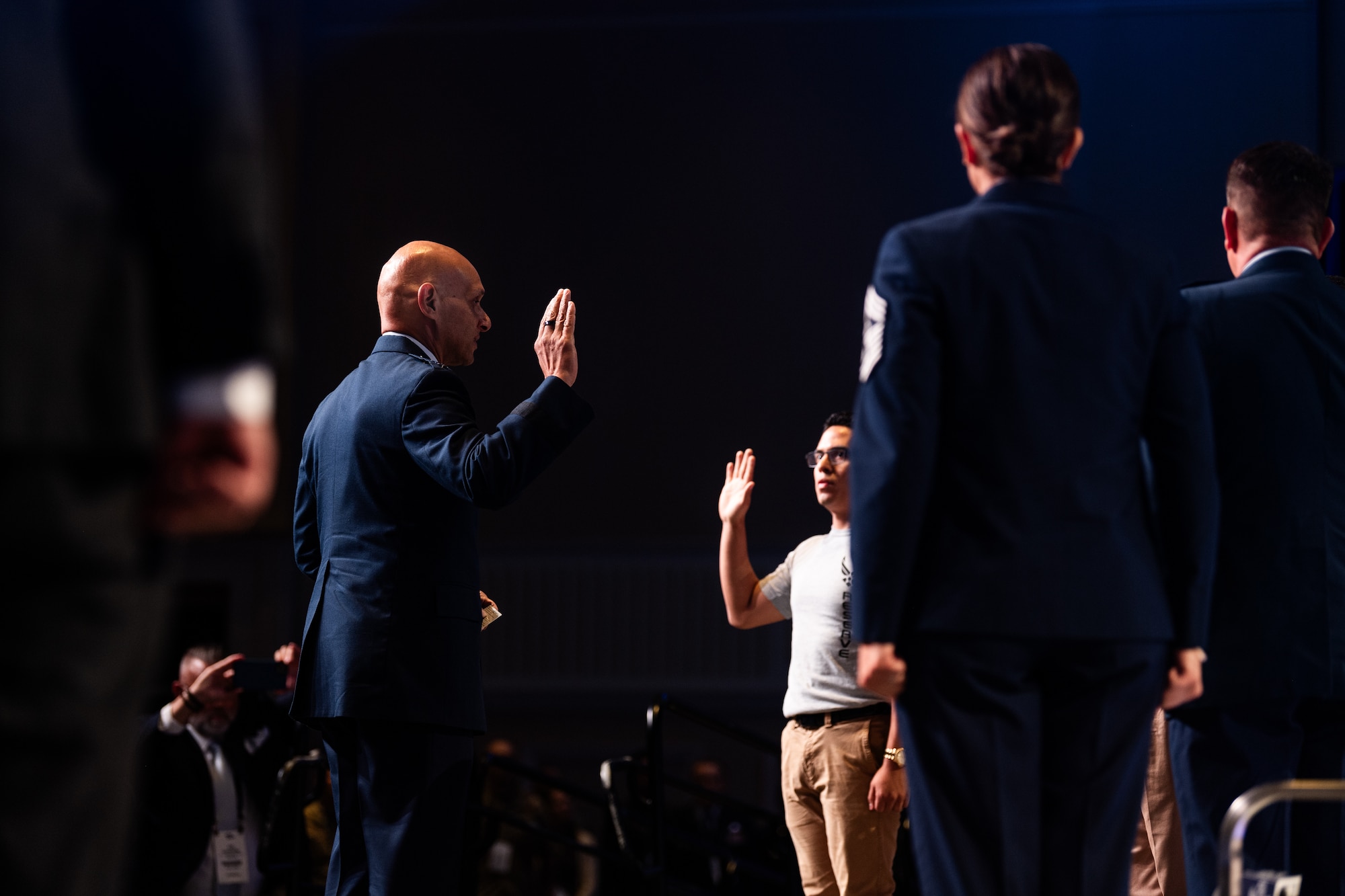 U.S. Air Force Lt. Gen. Brian S. Robinson, Air Force Education and Training Command commander, enlists members of the Department of the Air Force delayed entry program at the Air and Space Forces Association's Air, Space & Cyber Conference in National Harbor, Md., Sept. 11, 2023.