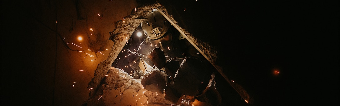 A U.S. Marine with Bravo Company, Chemical Biological Incident Response Force (CBIRF), saws through concrete and rebar while conducting search and rescue operations during Exercise Scarlet Response 2023 at the Guardian Centers in Perry, Georgia, July 19, 2023. Scarlet Response 2023 is specifically structured to evaluate the physical and mental abilities of the Marine Corps CBIRF personnel and their joint partners, the 911th Technical Rescue Engineer Company, during a simulated joint disaster response. (U.S. Marine Corps photo by Staff Sgt. Jacqueline A. Clifford)