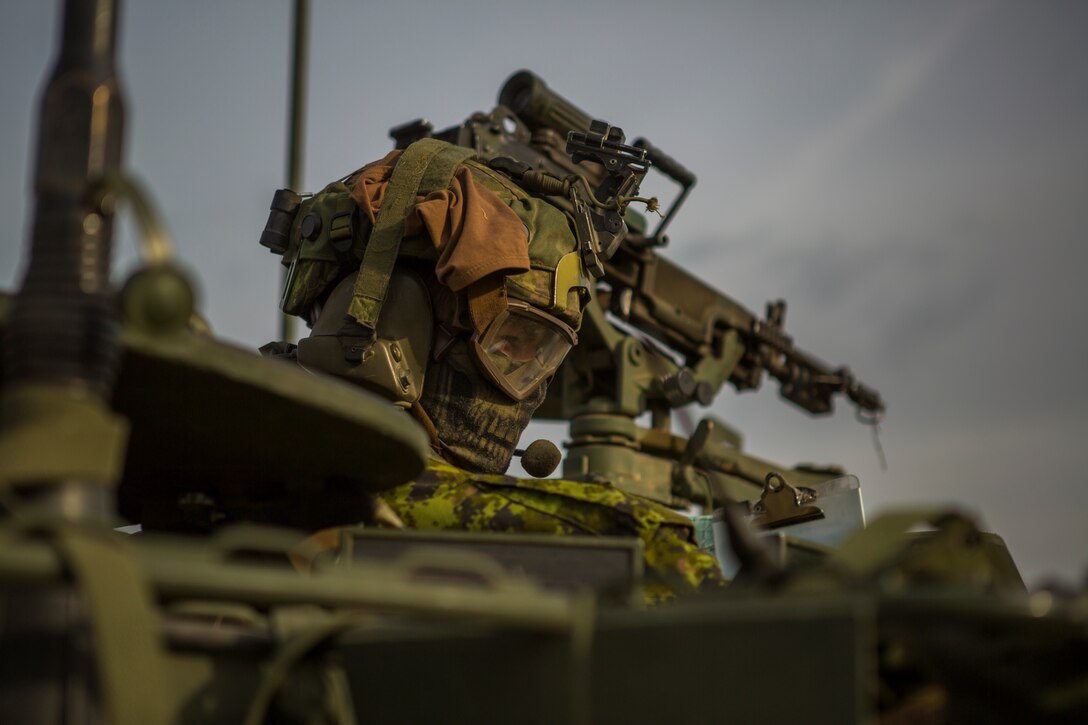 Canadian Army Capt. Dave Crosbie, a light armored vehicle captain with Charlie Company, 1st  Battalion Princess Patricia’s Canadian Light Infantry, scans the terrain during a movement in exercise Maple Resolve in Camp Wainwright, Alberta, Canada, May 13, 2019. Maple Resolve is an annual exercise, 3-week multinational simulated war, hosted by the Canadian Army bringing NATO allies together from across the world to share and learn tactics while strengthening foreign military ties. (U.S. Marine Corps photo by Cpl. Niles Lee)