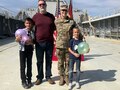 Female Soldier poses with her family after a promotion ceremony.