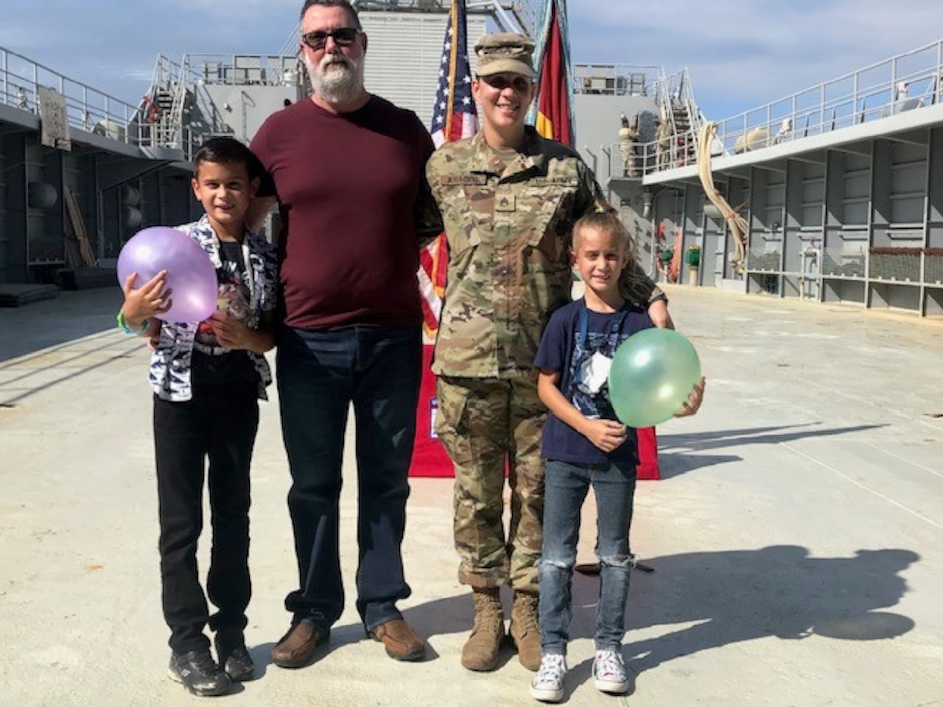 Female Soldier poses with her family after a promotion ceremony.