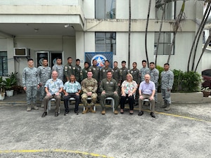 photo of a large group of U.S. Air Force military members and Philippine Air Force members standing in front of a building