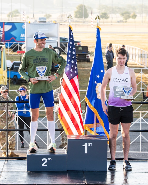 Men stand on award podium.