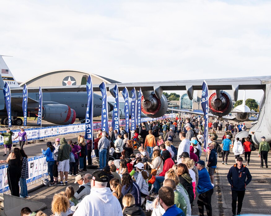 Spectators cheer at Air Force Marathon finish line.