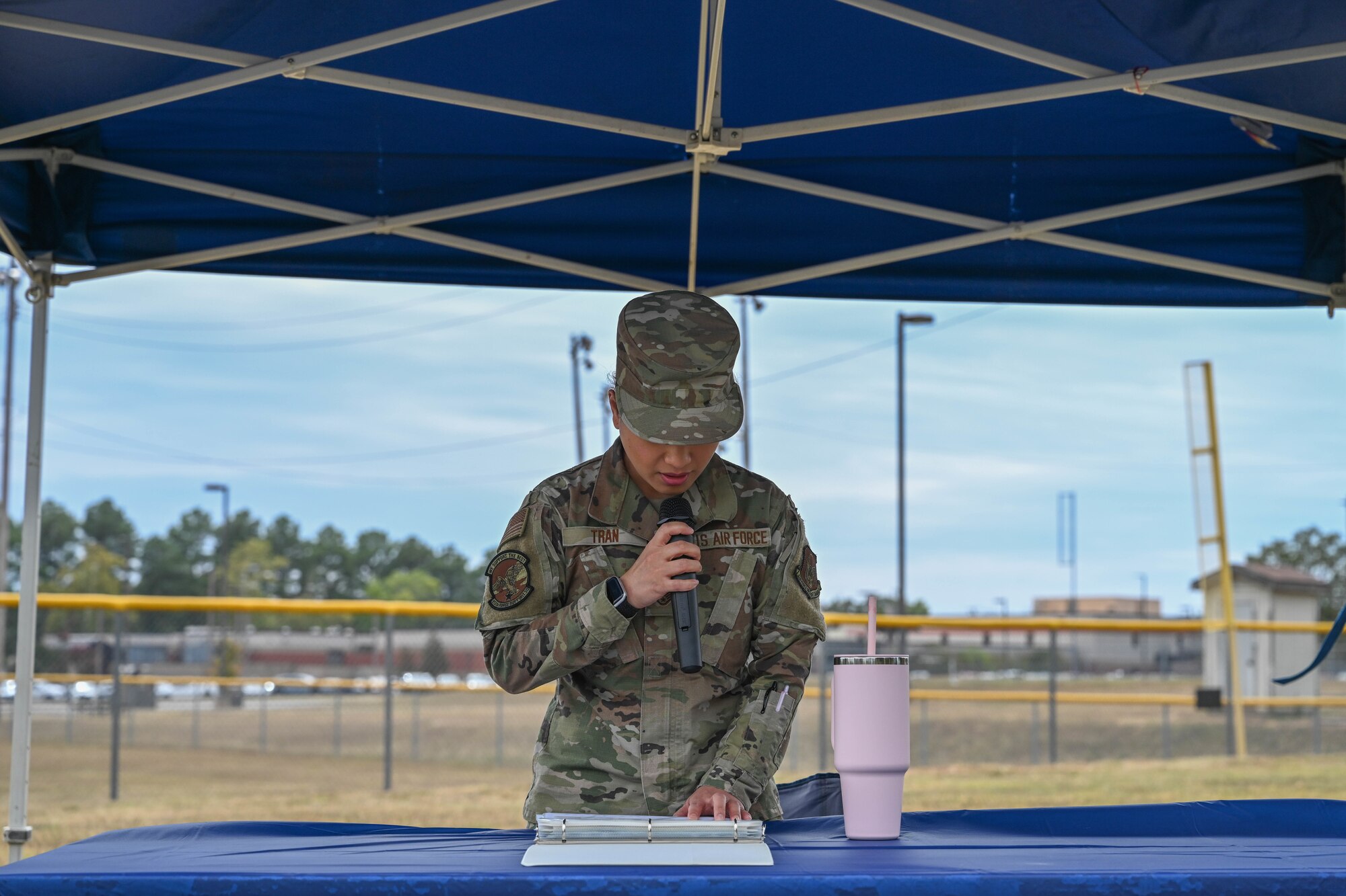 An Airman reads names from a list.
