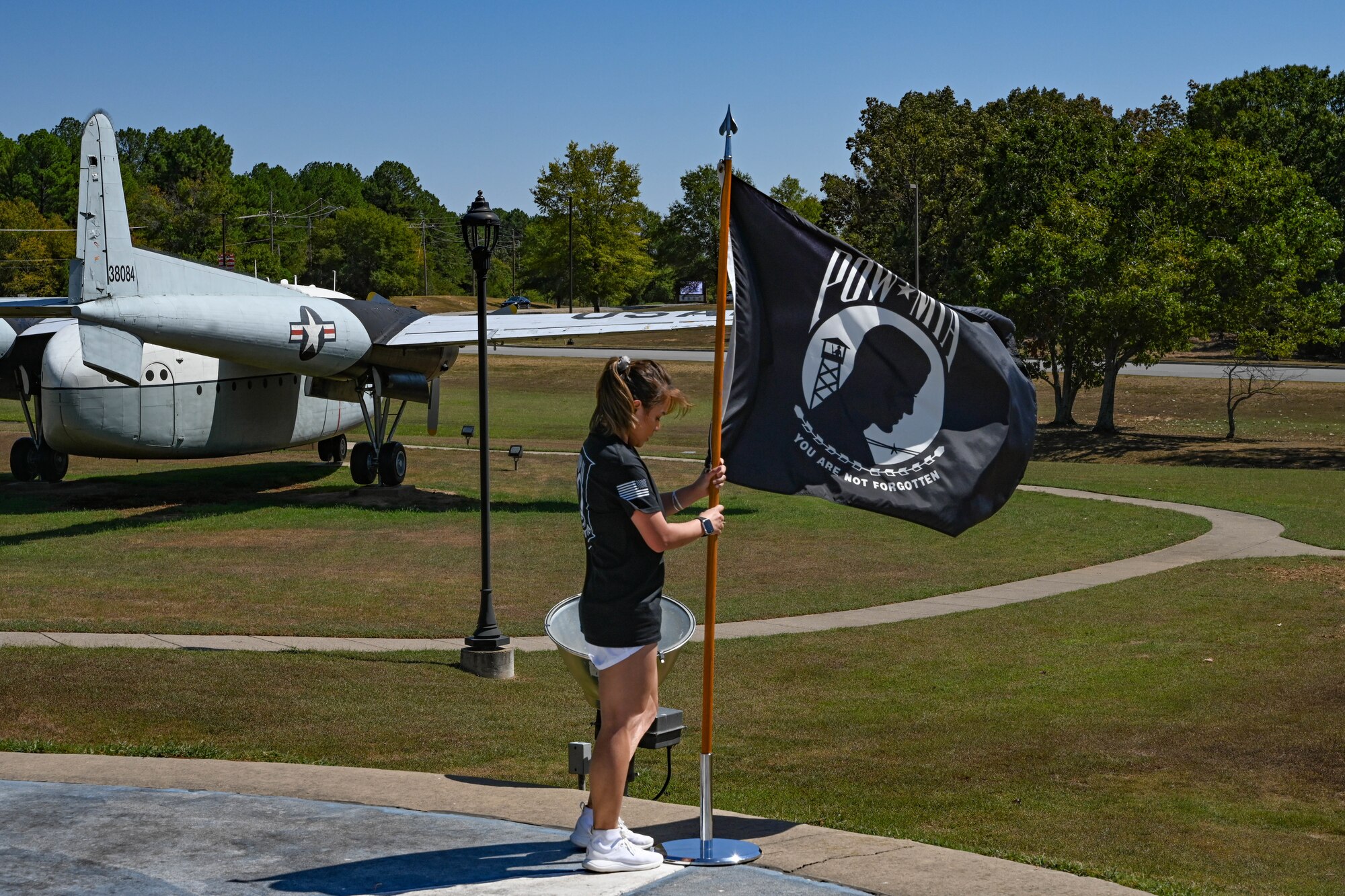 An Airman stakes a flag.
