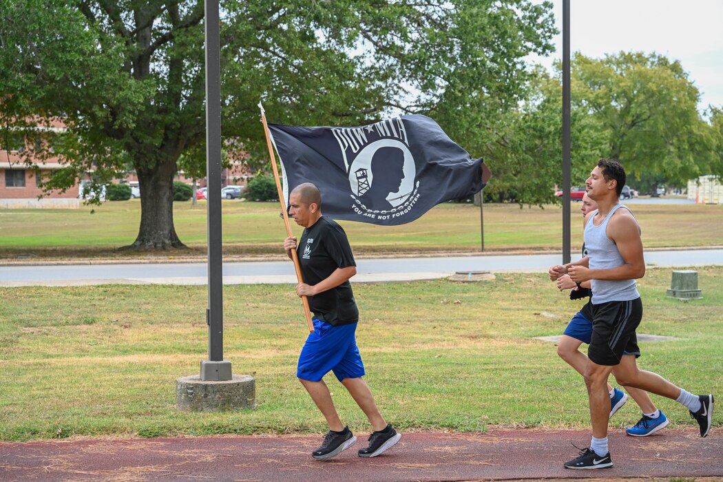 Airmen run on a track.