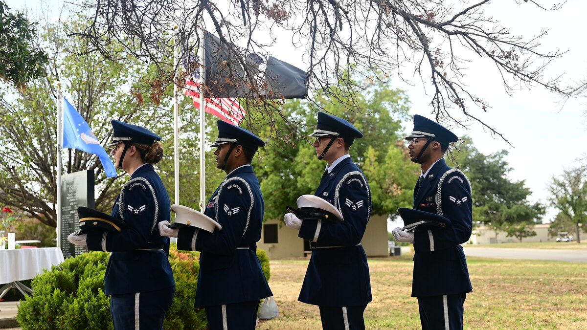 17th Training Wing base honor guardsmen prepare for the Prisoner of War/ Missing in Action table ceremony during the POW/MIA Remembrance Ceremony closing at the POW/MIA/Medal of Honor Memorial, Goodfellow Air Force, Texas, Sept. 15, 2023. Each member carried a cover that represented the Army, Navy, Marines and Air Force.