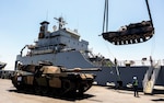 Australian Army M1A1 Abrams main battle tanks and vehicles are unloaded from the United States Army Vessel SSGT Robert T. Kuroda at Tanjung Perak Port in Indonesia during Exercise Super Garuda Shield 2023. At the invitation of Indonesian Armed Forces (TNI), Australia is contributing over 125 personnel from the Australian Defence Force (ADF) to Exercise Super Garuda Shield 2023 (SGS23). SGS23 is an TNI and United States Indo Pacific Command led bilateral training activity. It is focused on joint operations with international partners in and around East Java in Indonesia from 31 August to 13 September. Held since 2009, the ADF first participated in 2022, and in 2023 is contributing an Australian Army force element including a Troop of M1A1 Abrams tanks from the 1st Armoured Regiment. The contingent also includes an Infantry Platoon from the 10th/27th Battalion, Royal South Australian Regiment, command and control elements, and a range of armoured vehicles, trucks and recovery vehicles. (Photo by Australian Defence Force Cpl. Dustin Anderson)