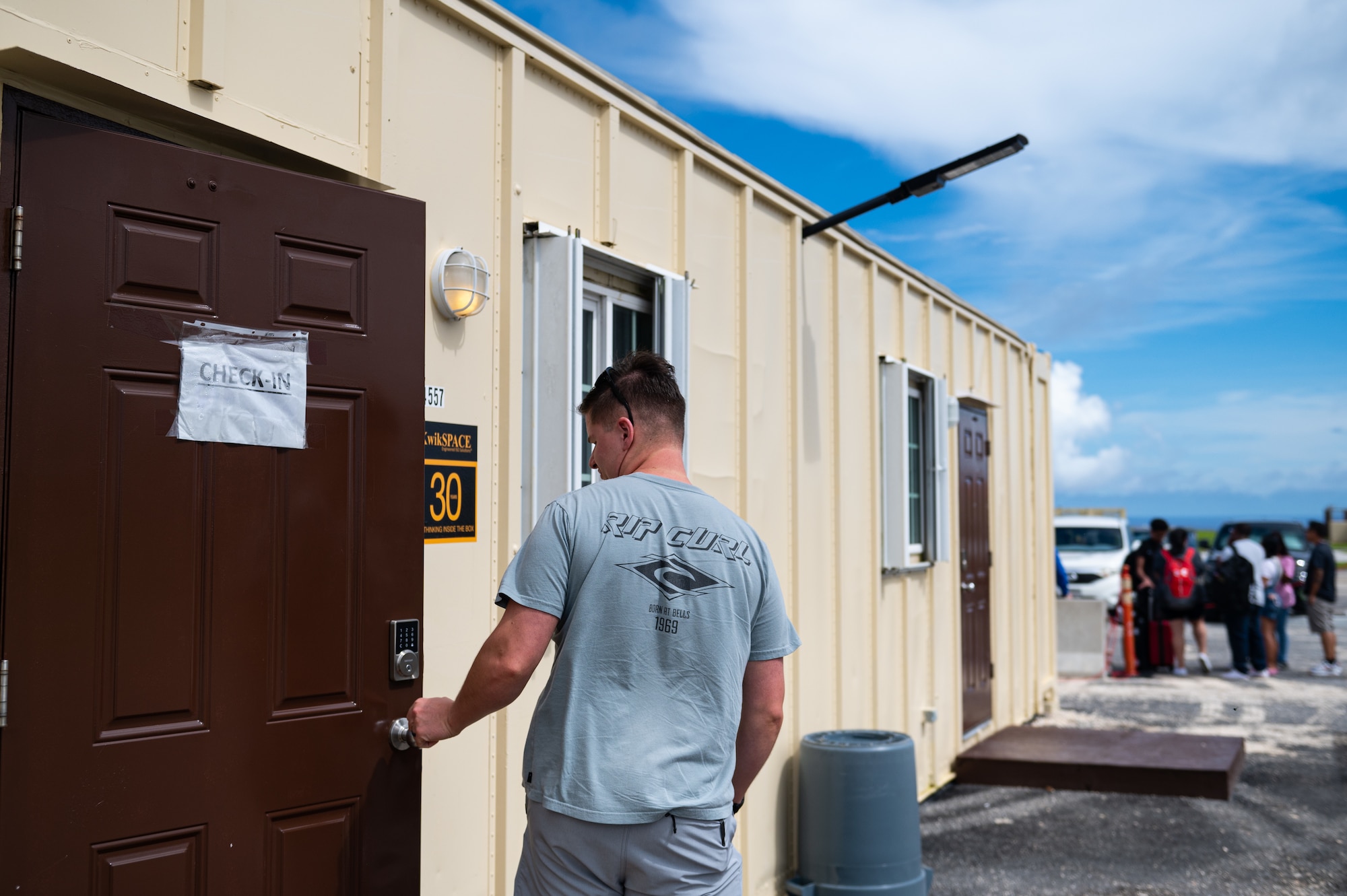 Departing members prepare to check in for their Patriot Express flight at Andersen Air Force Base, Guam, Sept. 17, 2023. The 734th Air Mobility Squadron created a makeshift passenger terminal, using portable office systems to support the freedom of movement for military personnel and their families after Typhoon Mawar. (U.S. Air Force photo by Staff Sgt. Suzie Plotnikov)