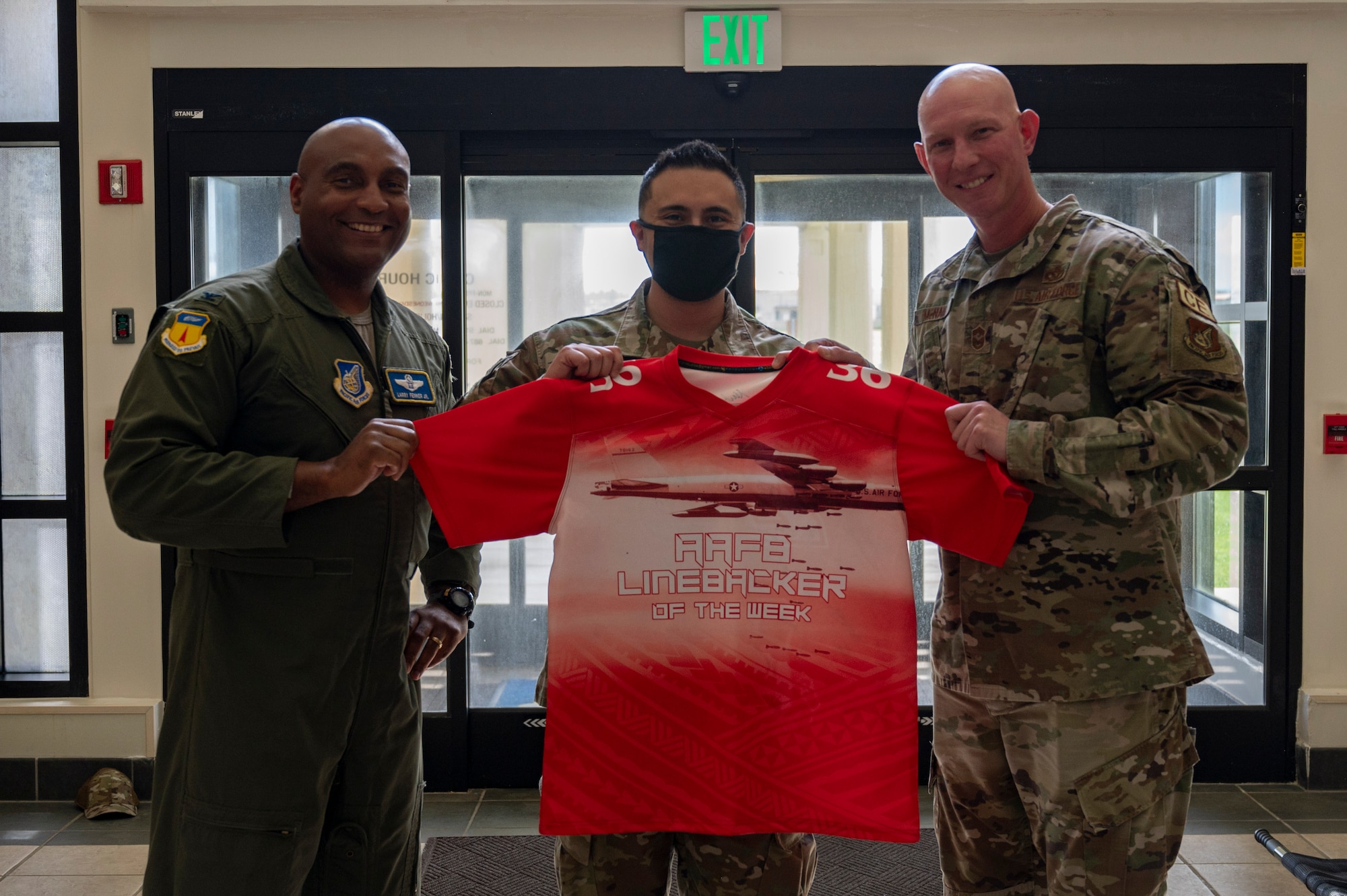 U.S. Air Force Staff Sgt. Salvador Rodriguez, the group training manager assigned to the 36th Medical Group, receives the Linebacker of the Week Award from U.S. Air Force Col. Larry Fenner, vice commander of the 36th Wing, and U.S. Air Force Chief Master Sgt. Donald McNair, the senior enlisted leader of the 36th Civil Engineering Squadron, at Andersen Air Force Base, Guam, Sept. 13, 2023. The Team Andersen Linebacker of the Week recognizes outstanding enlisted, officer, civilian and total force personnel who have had an impact on achieving Team Andersen’s mission, vision and priorities. (U.S. Air Force photo by Airman 1st Class Emily Saxton)
