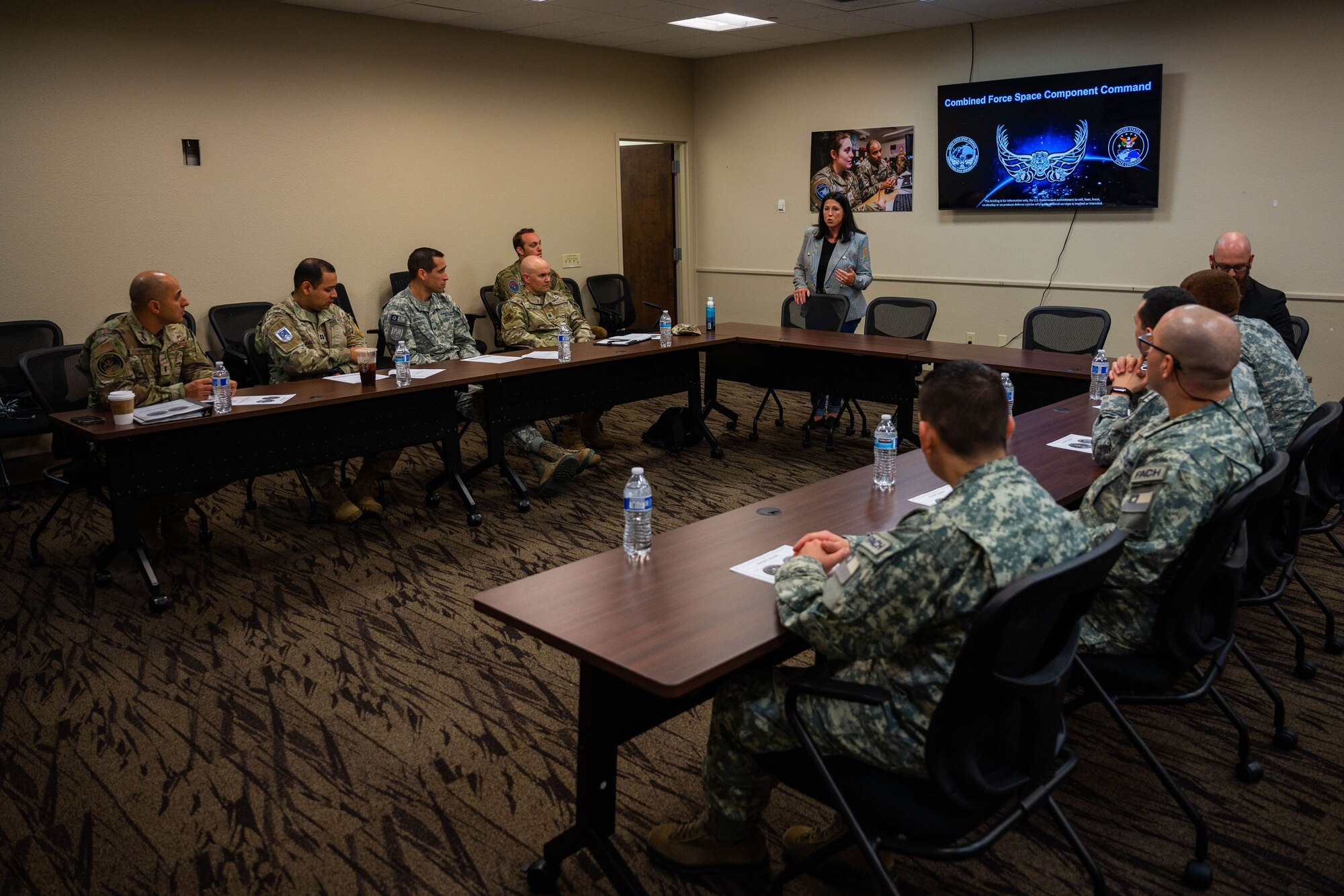 Jennifer Callaro, director and strategic engagements division chief, Combined Force Space Component Command, middle, provides a CFSCC brief to members of the Chilean Air Force and U.S. Southern Command at the 18 Space Defense Squadron on Vandenberg Space Force Base, Calif., Sept. 13, 2023. CFSCC hosted a delegation from partner nation Chile with discussions focused on Space Domain Awareness, aiming to increase the understanding and benefits of existing Space Situational Awareness sharing agreements, interoperability, and integration. (U.S. Space Force photo by Tech. Sgt. Luke Kitterman)