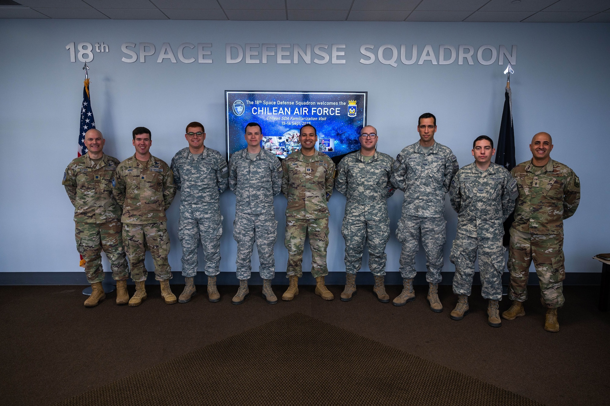 Members of the Chilean Air Force, U.S. Southern Command and 18th Space Defense Squadron stand together for a group photo in the 18 SDS building on Vandenberg Space Force Base, Calif., Sept. 14, 2023. The Combined Force Space Component Command hosted a delegation from partner nation Chile with discussions focused on Space Domain Awareness, aiming to increase the understanding and benefits of existing Space Situational Awareness sharing agreements, interoperability, and integration. (U.S. Space Force photo by Tech. Sgt. Luke Kitterman)