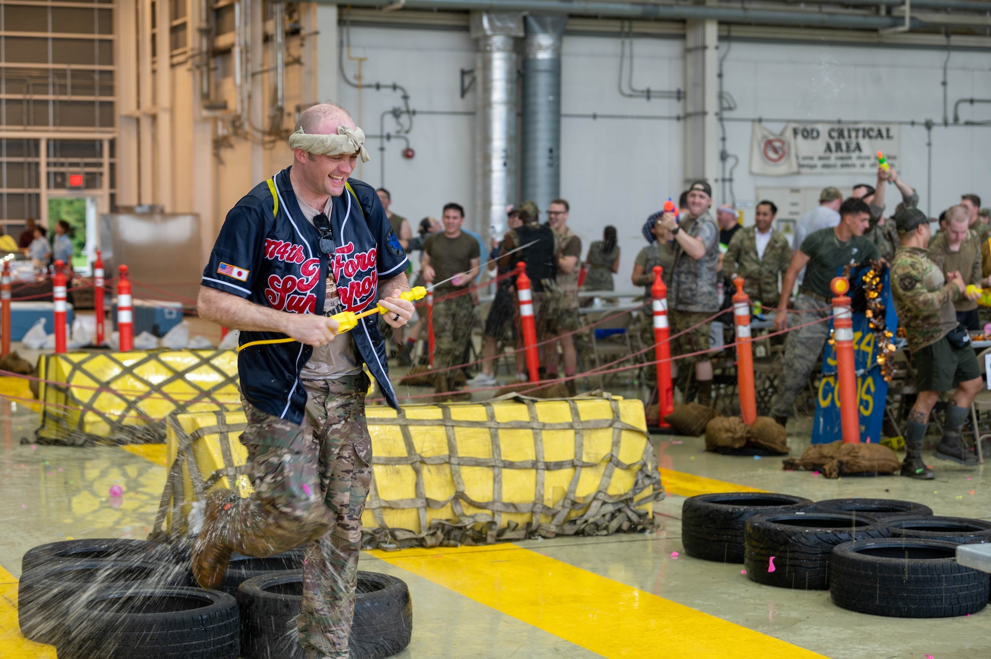 A service member navigates an obstacle course during a combat dining.
