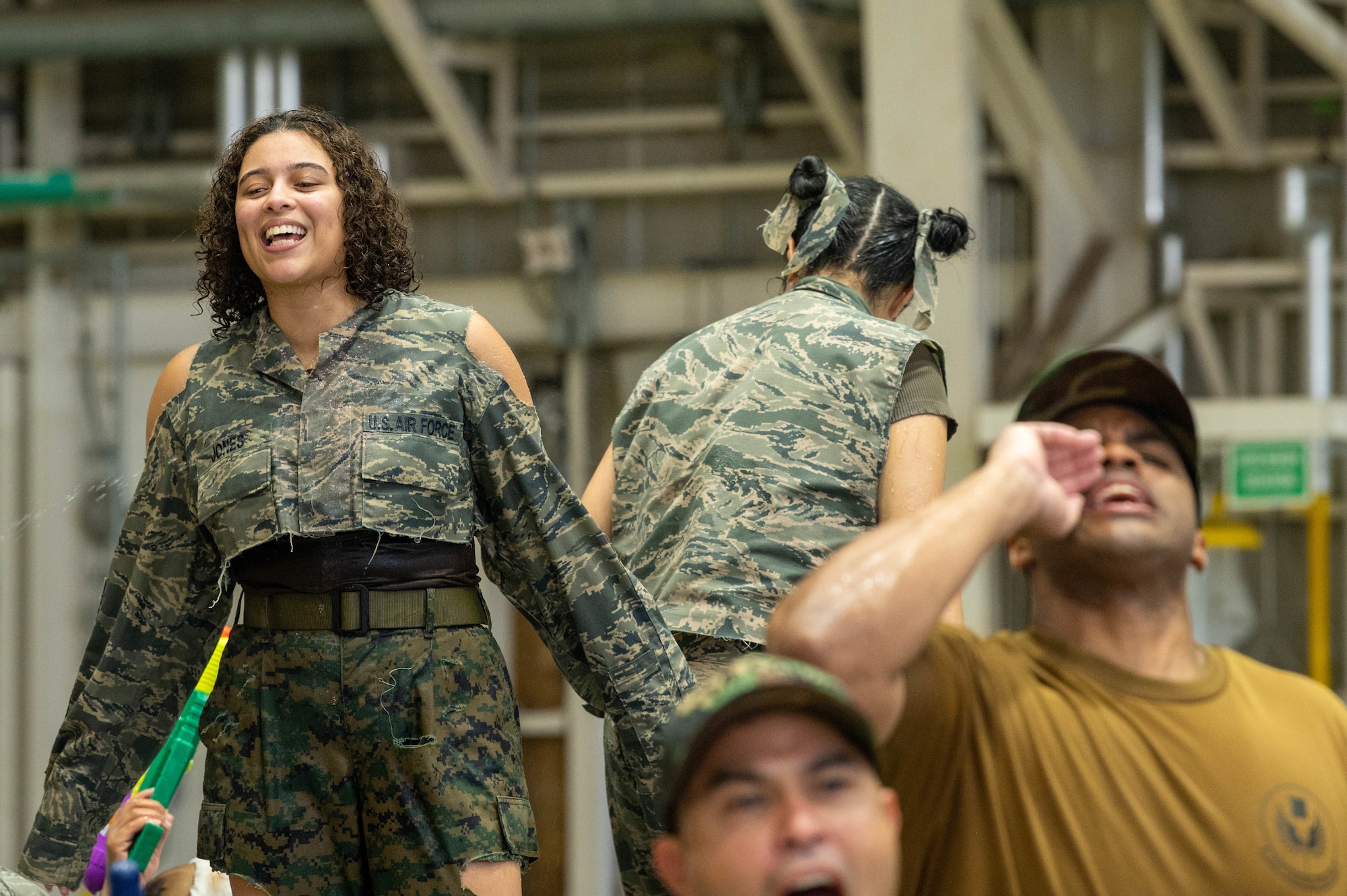 A service member stands atop a table during a combat dining-in.