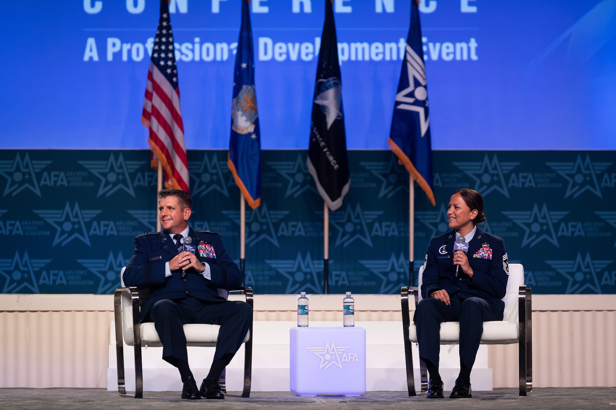 U.S. Air Force Brig. Gen. Christopher Amrhein, Air Force Recruiting Service commander, and U.S. Air Force Command Chief Master Sgt. Rebecca Arbona, Air Force Recruiting Service senior enlisted leader, make remarks at the Air and Space Forces Association's Air, Space & Cyber Conference in National Harbor, Md., Sept. 11, 2023.