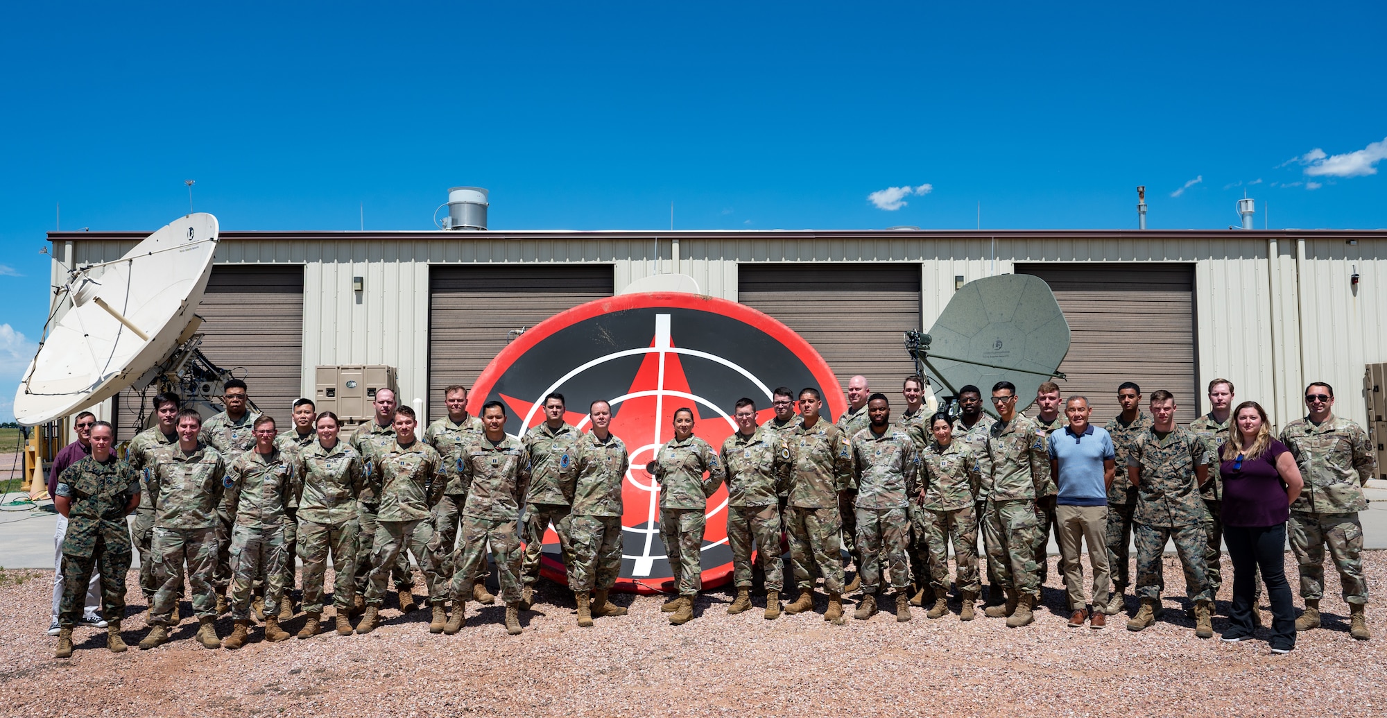 Members from the 527th Space Aggressor Squadron pose for a group photo on Schriever Space Force Base, Colorado, Aug. 16, 2023. The 527th SAS was recently named the Department of the Air Force (DAF) Outstanding Level II Electromagnetic Warfare Unit of the Year, a testament to their success of exposing the joint force to the physical and psychological rigors of going toe-to-toe with a thinking, breathing adversary. (U.S. Air Force photo by 1st Lt. Charles Rivezzo)