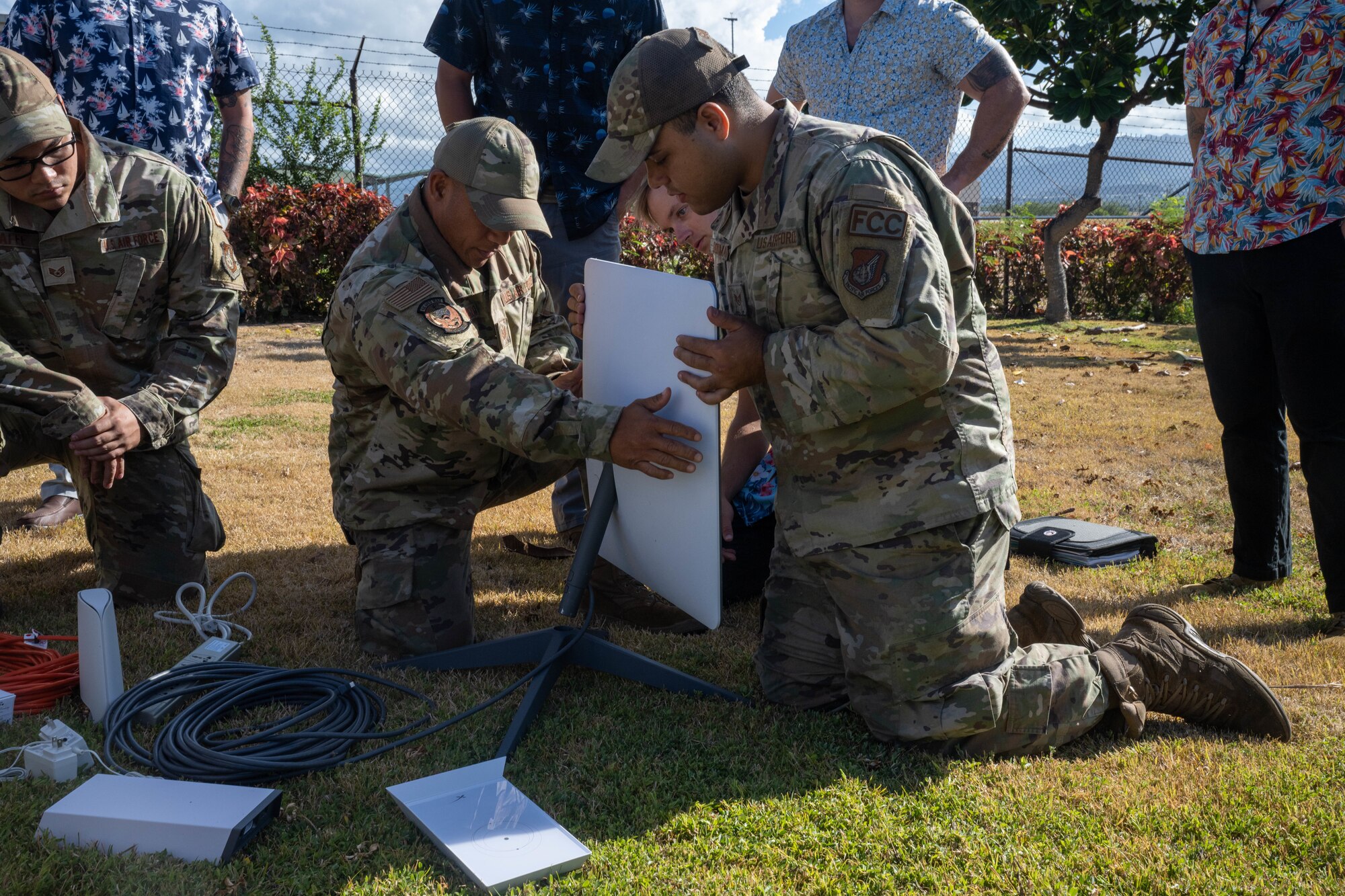 Airmen from the 15th Maintenance Squadron practice setting up a commercial satellite kit during a demonstration at Joint Base Pearl Harbor-Hickam, Hawaii, August 11, 2023. Members from the 15th MXS are in the early stages of using the commercial satellite system to improve connectivity to prepare for agile combat employment concept deployments. (U.S. Air Force photo by Senior Airman Makensie Cooper)