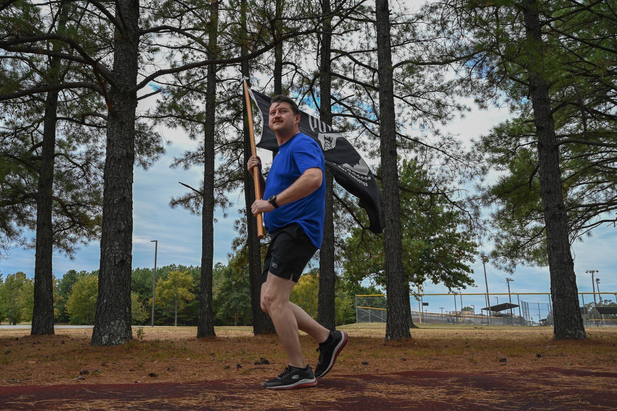 An Airman runs on a track.