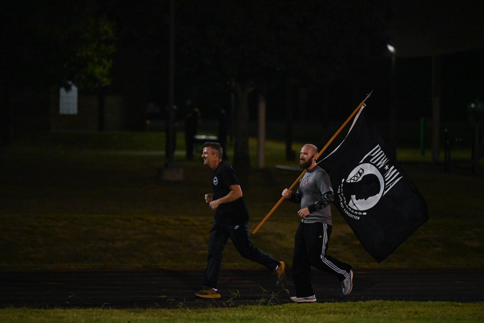Airmen run on a track.