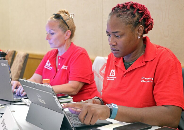 Destynee Hives-McCray, right, mission specialist, private property debris removal team, U.S. Army Corps of Engineers, and Fort Worth District project manager and Vandi Leheny, left, mission manager, PPDRT, and USACE, Fort Worth District project manager prepare schedules and maintain accountability at the emergency field office on Maui, Sept. 13. Hives-McCray played basketball at Southern Methodist University and Texas Christian university from 2011 to 2016 and attributes lessons learned as an athlete with many life and career lessons.