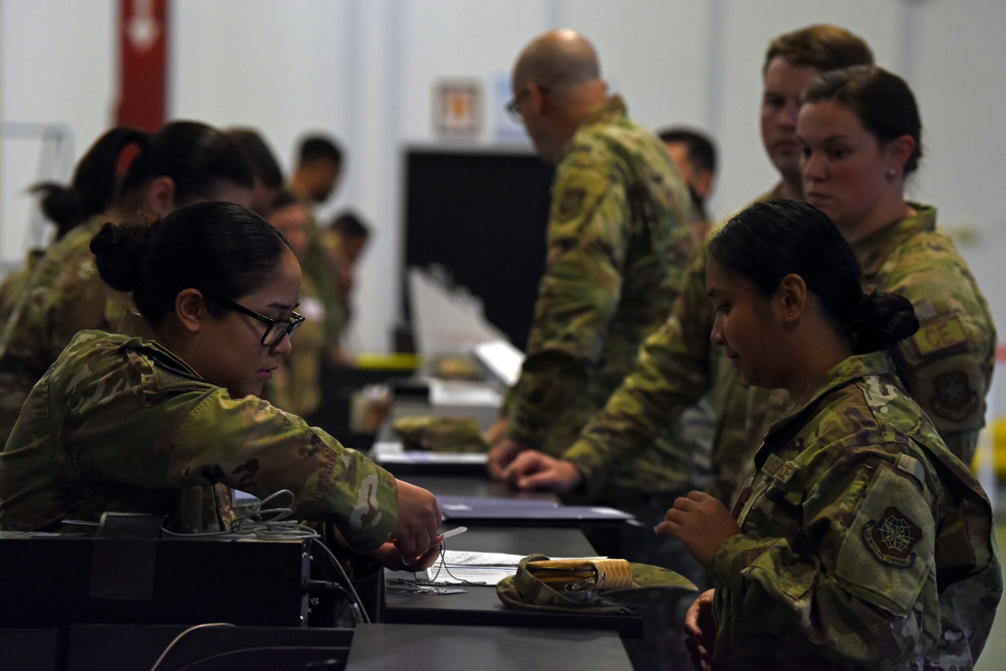 Team McChord Airmen process through a pre-deployment function line during Exercise Rainier War 23A at Joint Base Lewis-McChord, Washington, Sept. 19, 2023. Rainier War is a 62d Airlift Wing exercise designed to evaluate the ability to generate, employ and sustain in-garrison and forward deployed forces. These exercises are necessary in assessing and maintaining wartime operational tempos, ensuring command and control across multiple locations. During the exercise, Airmen will respond to scenarios that replicate today’s contingency operations and will address full-spectrum readiness against modern threats brought on by peer adversaries. (U.S. Air Force photo by Staff Sgt. Zoe Thacker)