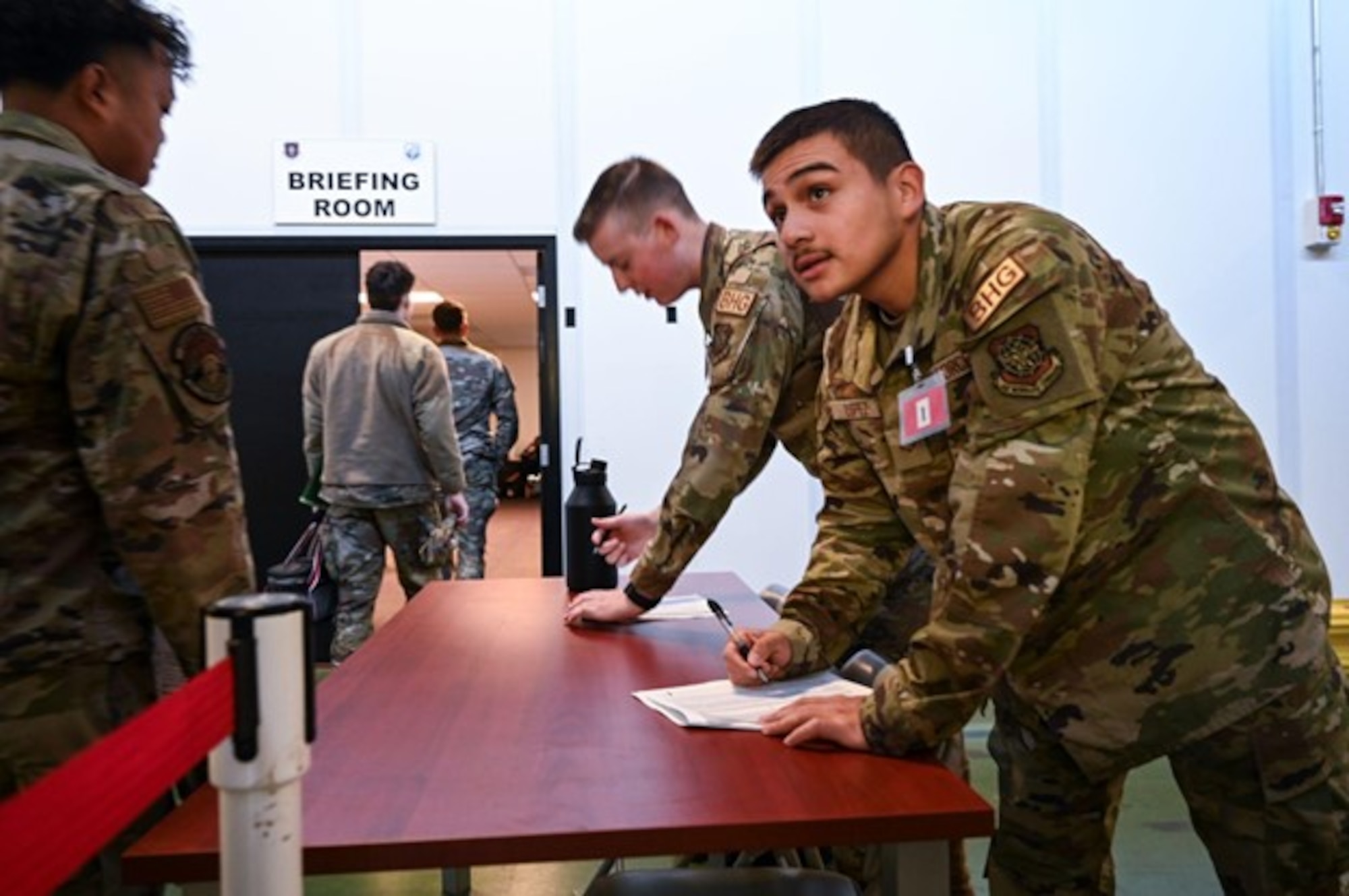 A U.S. Air Force Airman 1st Class Alizeh Lopez, McChord Field Honor Guard member, checks in deployers at the Exercise Rainier War 23 deployment line at Joint Base Lewis-McChord, Washington, Sept. 19, 2023. Rainier War is an exercise led by the 62d Airlift Wing designed to evaluate the ability to generate, employ and sustain in-garrison and forward deployed forces. These exercises are necessary in assessing and maintaining wartime operational tempos, ensuring command and control across multiple locations. During the exercise, Airmen will respond to scenarios that replicate today’s contingency operations and will address full-spectrum readiness against modern threats brought on by peer adversaries. (U.S. Air Force photo by Senior Airman Colleen Anthony)