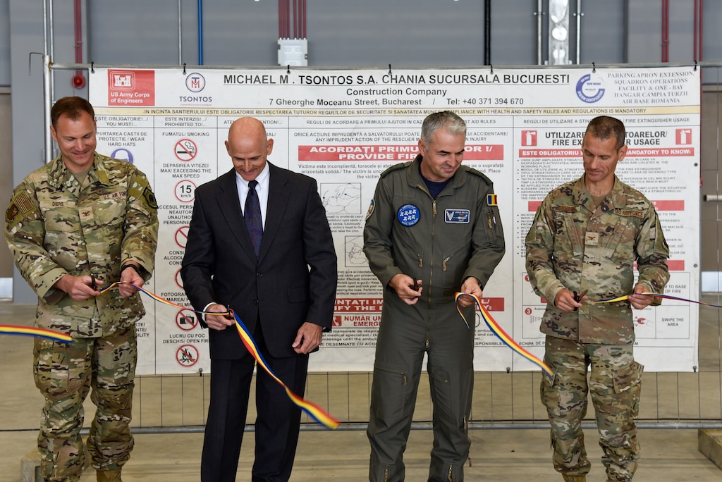 guys cutting a ribbon