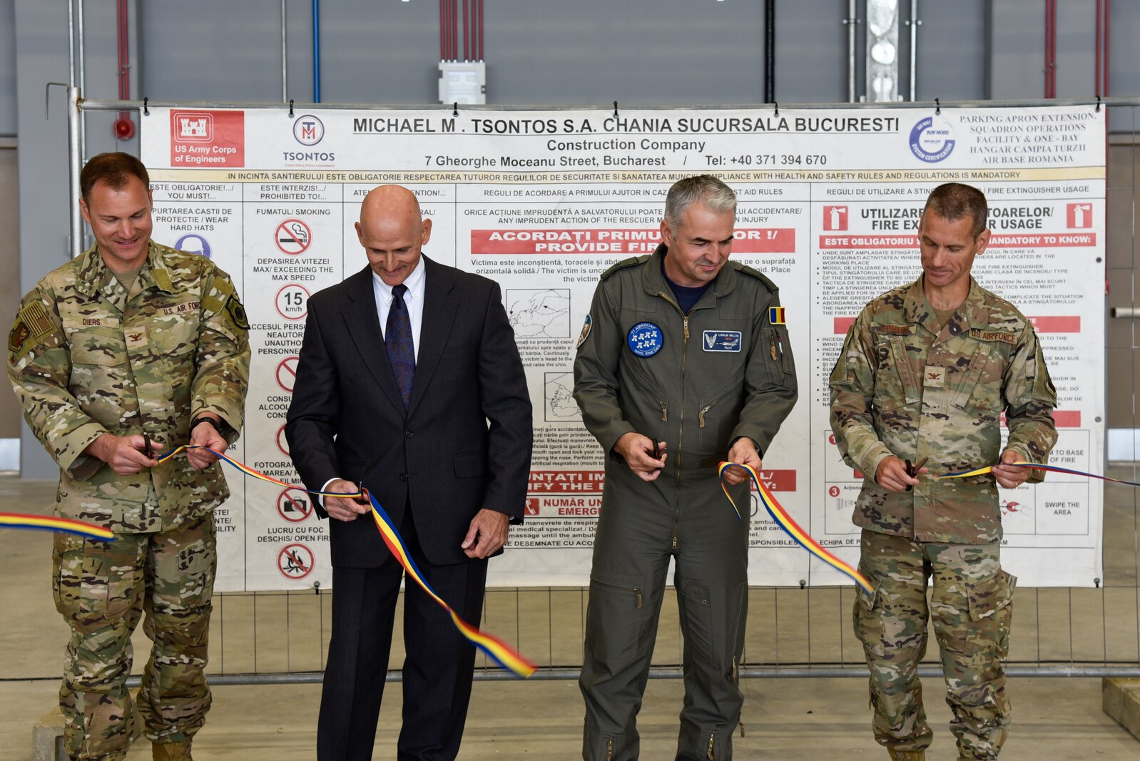 U.S. and Romanian official cutting a ribbon