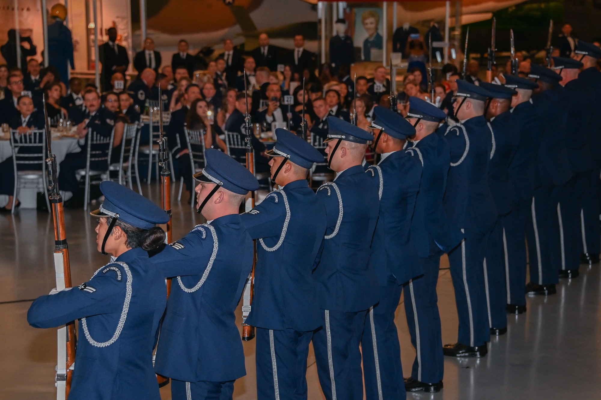 Military members in uniform standing in a line.