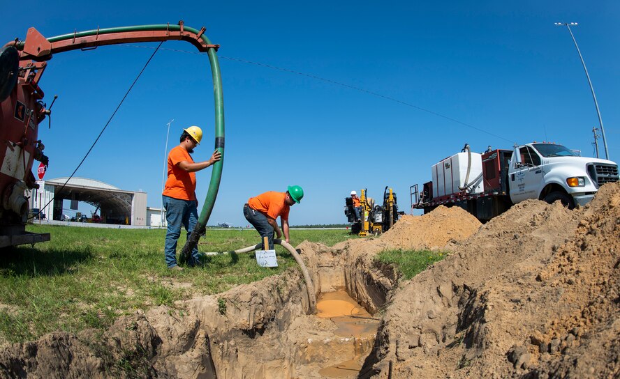 Construction workers create a path for electrical cables Sept. 19 at Eglin Air Force Base, Florida.  The electrical cables will connect to the DOD’s first ever electric aircraft charging station.  (U.S. Air Force photo/Samuel King Jr.)