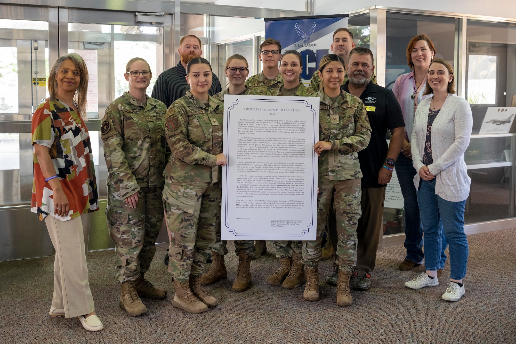 35th Fighter Wing suicide prevention facilitators stand with Misawa’s Suicide Prevention Proclamation at Misawa Air Base, Japan.