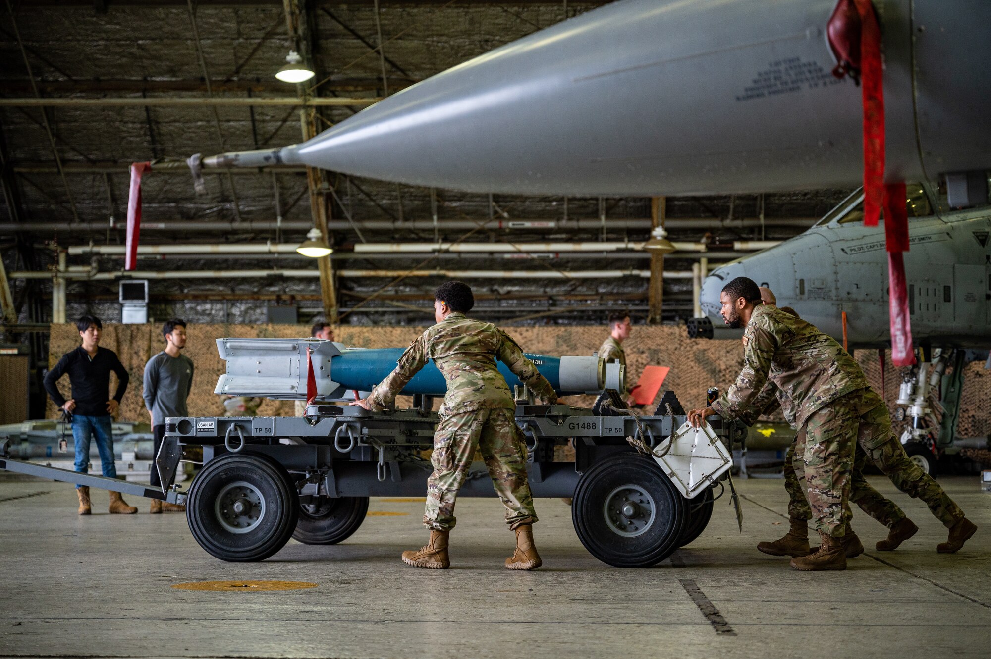 U.S. Air Force Airmen assigned to the 25th Fighter Generation Squadron compete in a quarterly load crew competition at Osan Air Base, Republic of Korea, Sept. 15, 2023. Load crew members were evaluated on safety, speed, reliability, technical errors and use of their respective loading checklist. This competition fosters heightened performance for real-world operations by allowing Airmen to hone their skills and decision-making abilities in high-pressure situations, ultimately ensuring they can maintain operational superiority anytime and anywhere. (U.S. Air Force photo by Staff Sgt. Thomas Sjoberg)