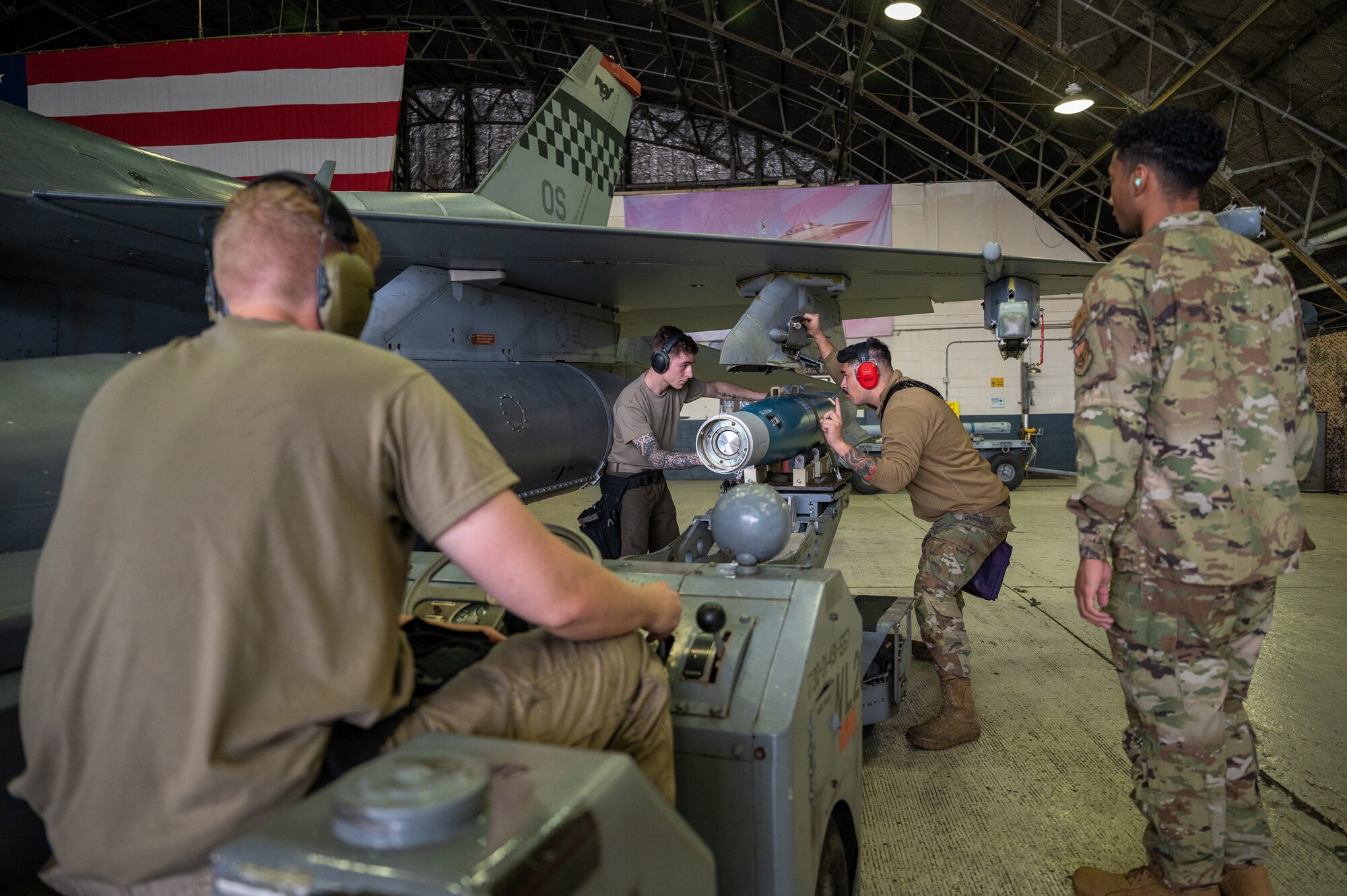 U.S. Air Force weapons load crew members assigned to the 36th Fighter Generation Squadron load munitions onto an F-16 Fighting Falcon during a quarterly load crew competition at Osan Air Base, Republic of Korea, Sept. 15, 2023. Load crew competitions sharpen the skill efficiency of Airmen who arm and maintain 51st Fighter wing aircraft, ultimately bolstering the Wing's combat readiness. (U.S. Air Force photo by Staff Sgt. Thomas Sjoberg)