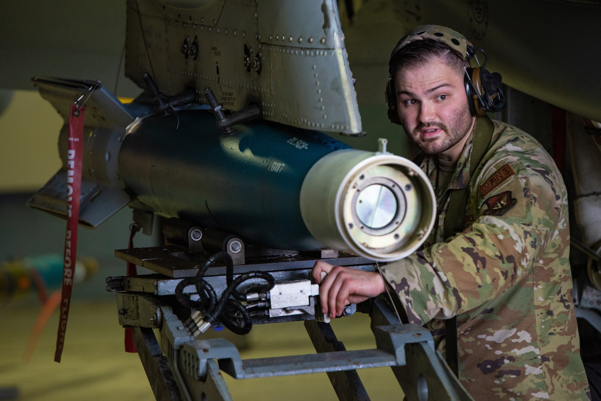 U.S. Air Force Staff Sgt. Dylan Zimmermann, 25th Fighter Generation Squadron load crew chief, guides munitions to be mounted on an A-10C Thunderbolt II pylon station during a quarterly load crew competition at Osan Air Base, Republic of Korea, Sept. 15, 2023. Loading procedures were evaluated to guarantee the accurate execution of all necessary steps, placing teams under simulated real-world stress to reinforce their ability to perform flawlessly in high-pressure situations. (U.S. Air Force photo by Airman 1st Class Chase Verzaal)