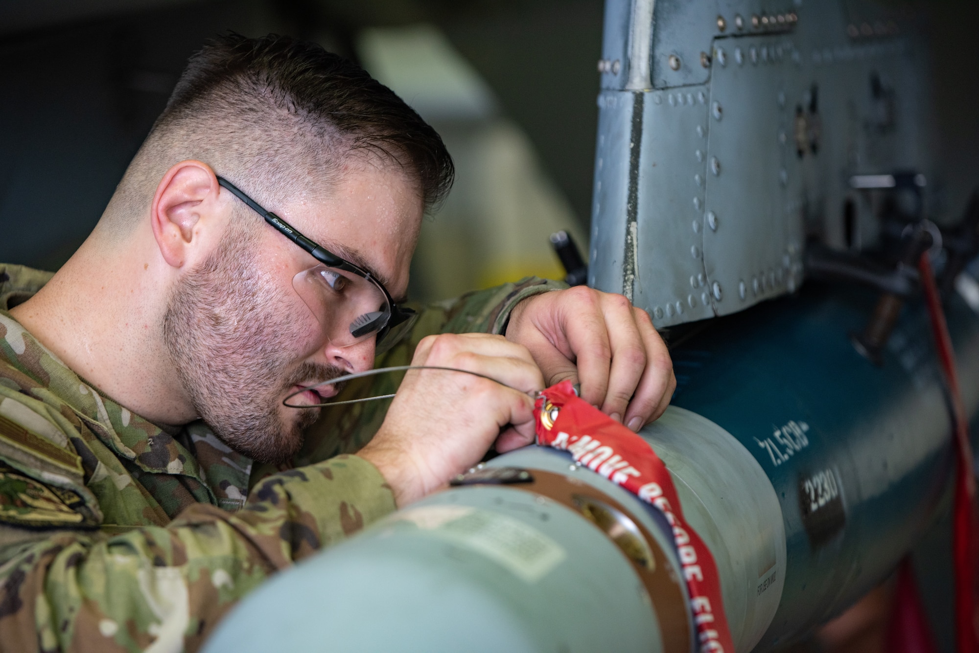 U.S. Air Force Staff Sgt. Dylan Zimmermann, 25th Fighter Generation Squadron load crew chief, secures munitions on an A-10C Thunderbolt II pylon station during a quarterly load crew competition at Osan Air Base, Republic of Korea, Sept. 15, 2023. Competing against other teams in a realistic, high-stress environment enhances speed and accuracy for potential real-world scenarios. (U.S. Air Force photo by Airman 1st Class Chase Verzaal)