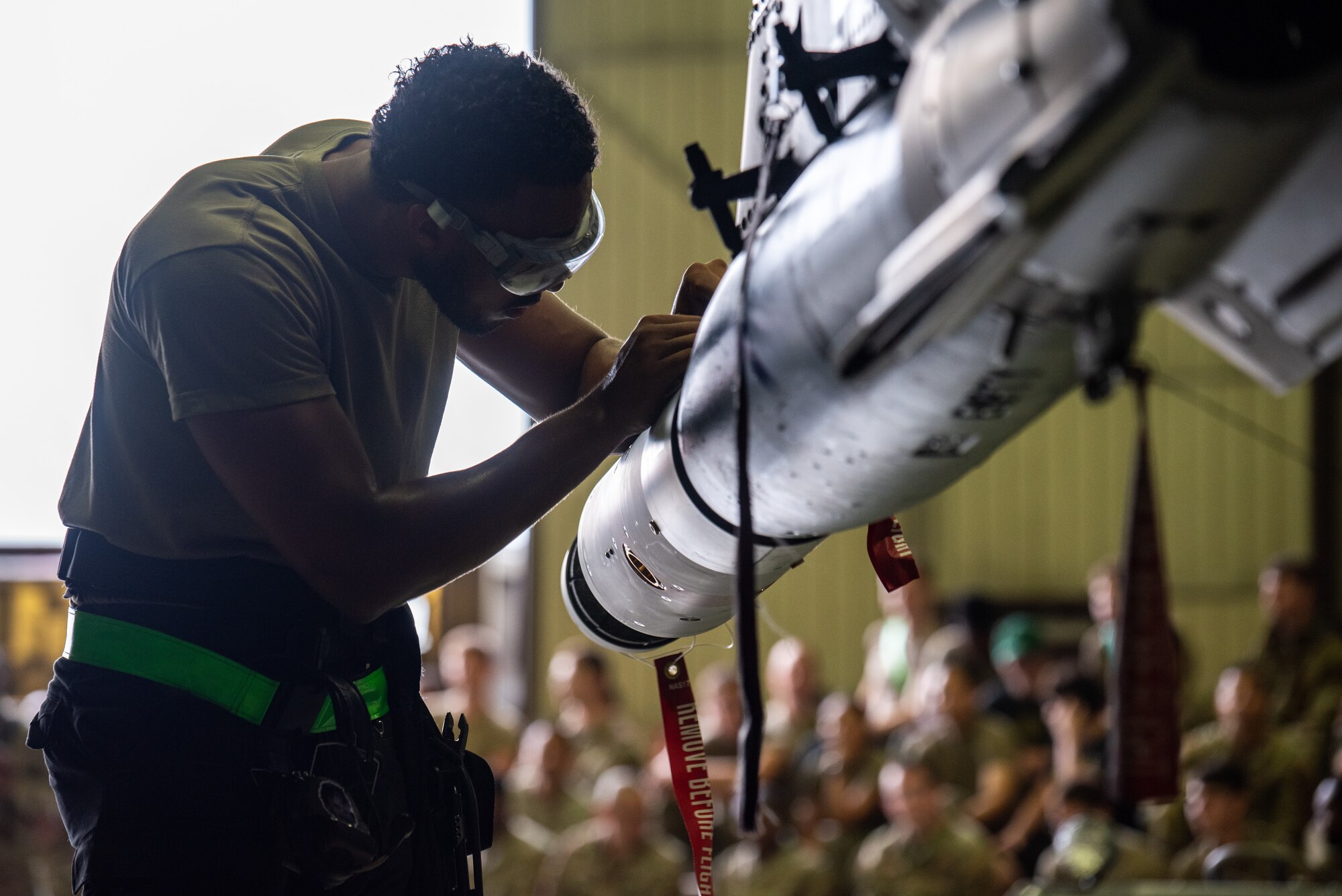 U.S. Air Force Airman 1st Class Putreal Morgan, 25th Fighter Generation Squadron load crew member, secures munitions onto an A-10C Thunderbolt II pylon station during a quarterly load crew competition at Osan Air Base, Republic of Korea, Sept. 15, 2023. In these competitions, teams are meticulously evaluated on speed and precision of loading munitions. Critical routine assessments bolster readiness to respond effectively in the event of potential threats. (U.S. Air Force photo by Airman 1st Class Chase Verzaal)