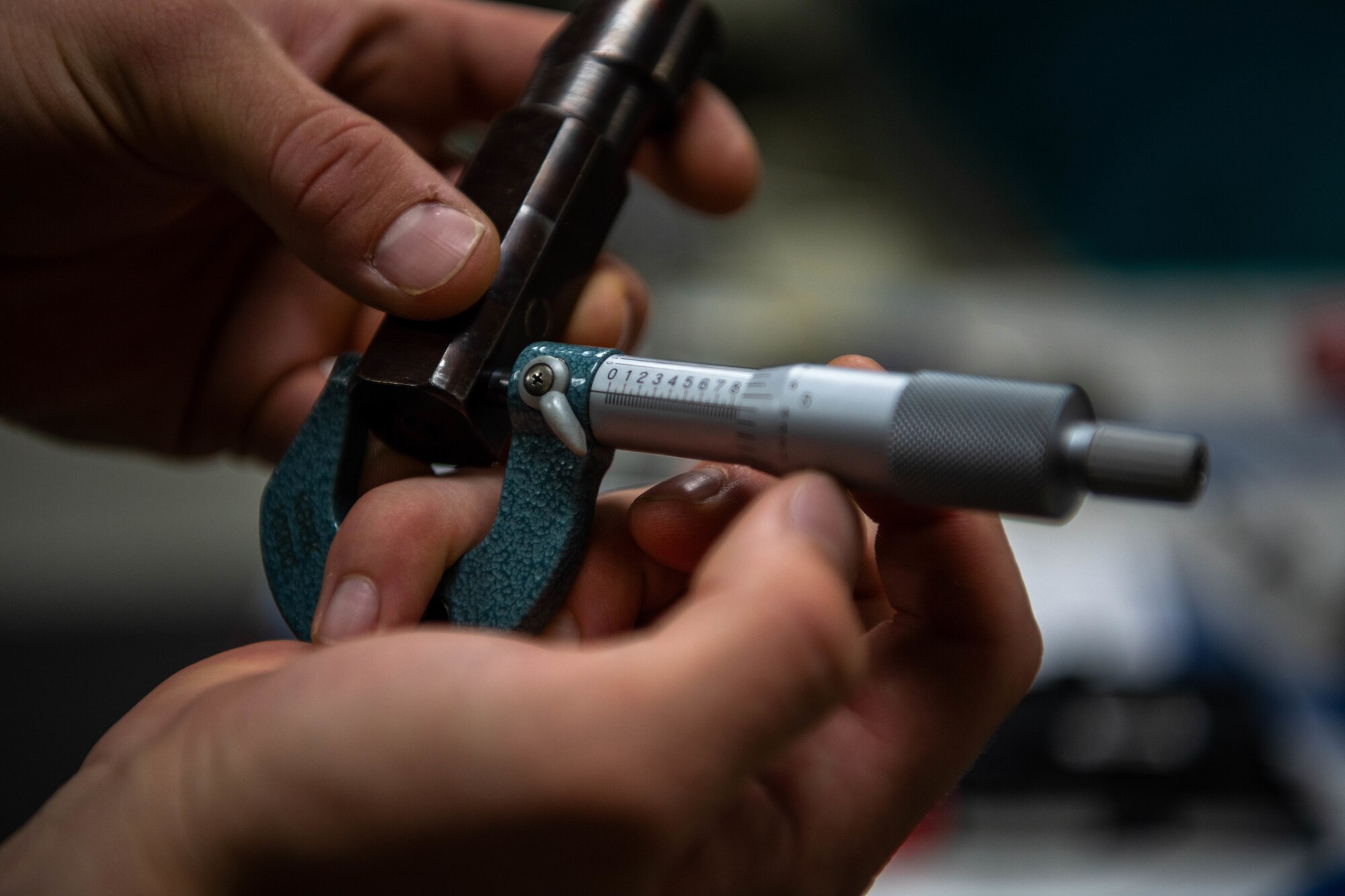 A close up shot of a micrometer tool being used to measure another metals technology tool.