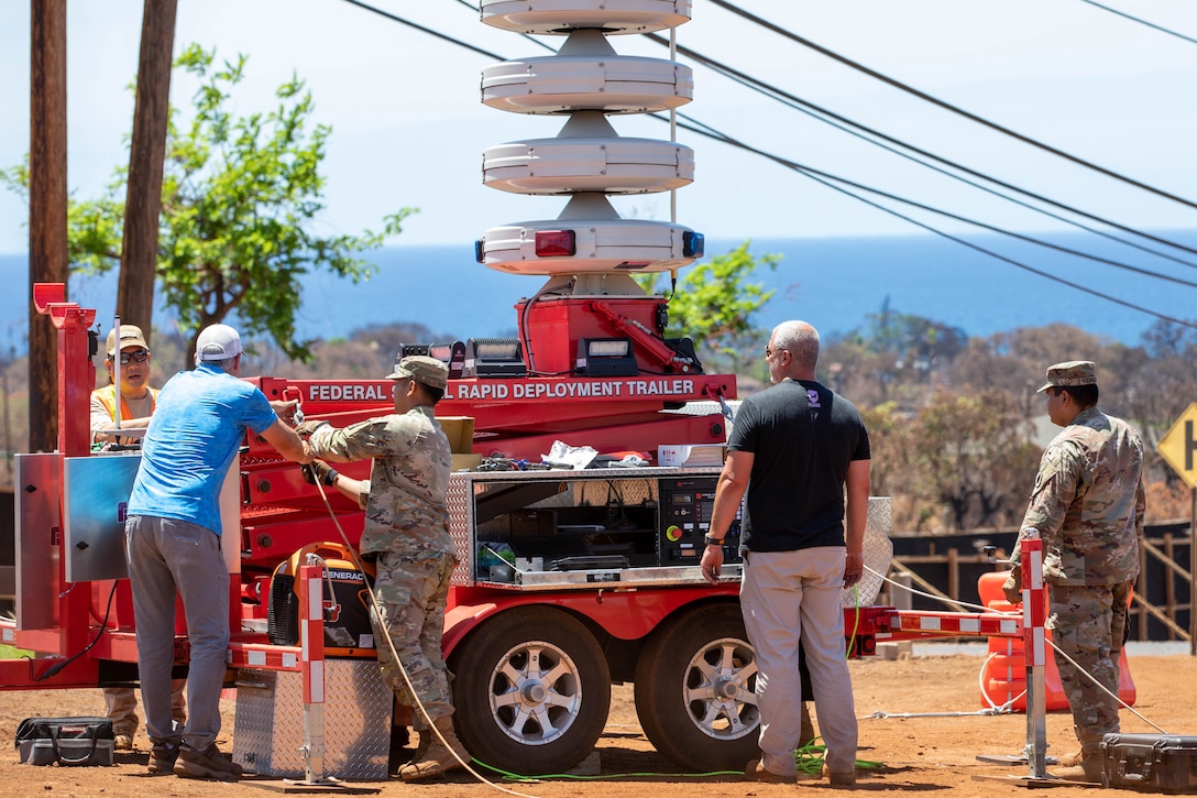 Service members conduct set up operations of a rapid response emergency siren.
