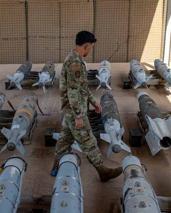Photo of a man walking between bombs
