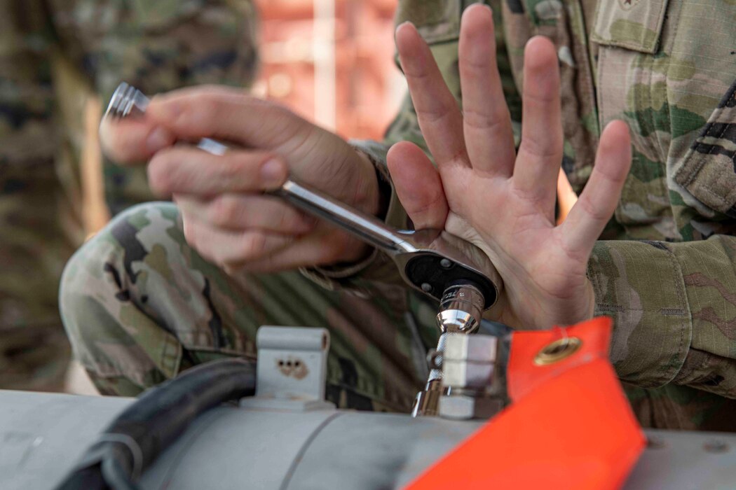 Photo of a socket wrench being used on a bomb