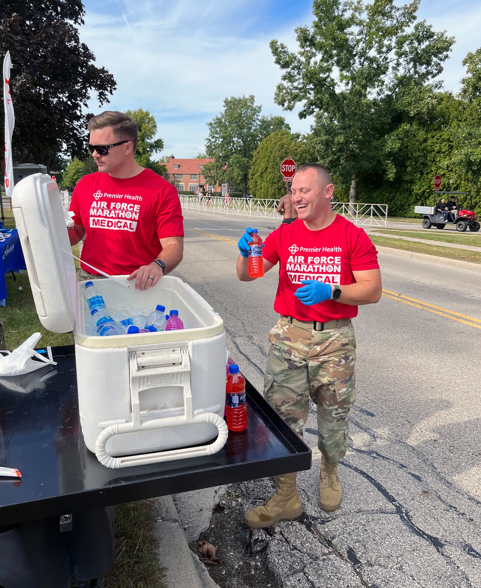 U.S. Air Force 1st Lt. Trevor Moyer, left, and Tech. Sgt. Codee Arthur, 445th Aeromedical Staging Squadron, prepare to hand out electrolyte solution and water to runners of the full marathon in Medical Tent L between mile marker 17 and 18 during the Air Force Marathon at Wright-Patterson Air Force Base Ohio, Sept. 16, 2023. More than 8,000 runners competed in the marathon which included a half marathon, 10K run, 5K run and more in addition to the full marathon. (Courtesy photo)