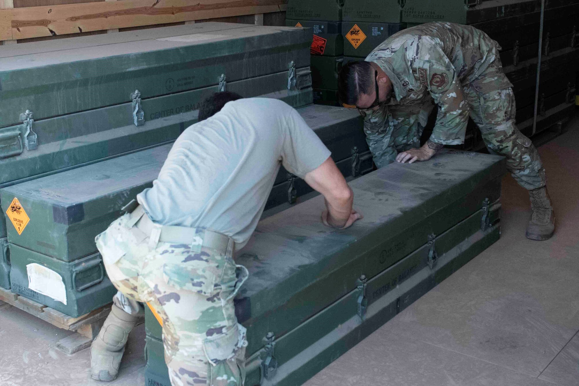 Photo of two men moving a rectangular box