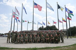 The 2023 International Senior Non-Commissioned Officer Development course class pose for a photograph in front of the Inter-American Air Forces Academy on Joint Base San Antonio-Lackland, Texas, September 18, 2023. The INLEAD course is held every summer, sponsored by the International Air Reserve Symposium (IARS) which was established in 1992. The location is changed every five years to allow participants to experience the military heritage of different host nations, while learning leadership development in an international integrated environment. (U.S. Air Force photo by Senior Airman Brittany Wich)