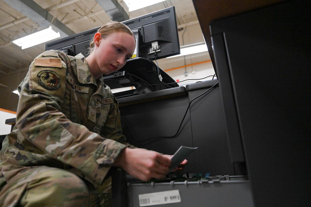 Airman 1st Class Alily Kliewer, 28th Logistics Readiness Squadron light ground vehicle fleet management and analysis technician, files a work order receipt, Sept. 8, 2023, at Ellsworth Air Force Base, South Dakota.