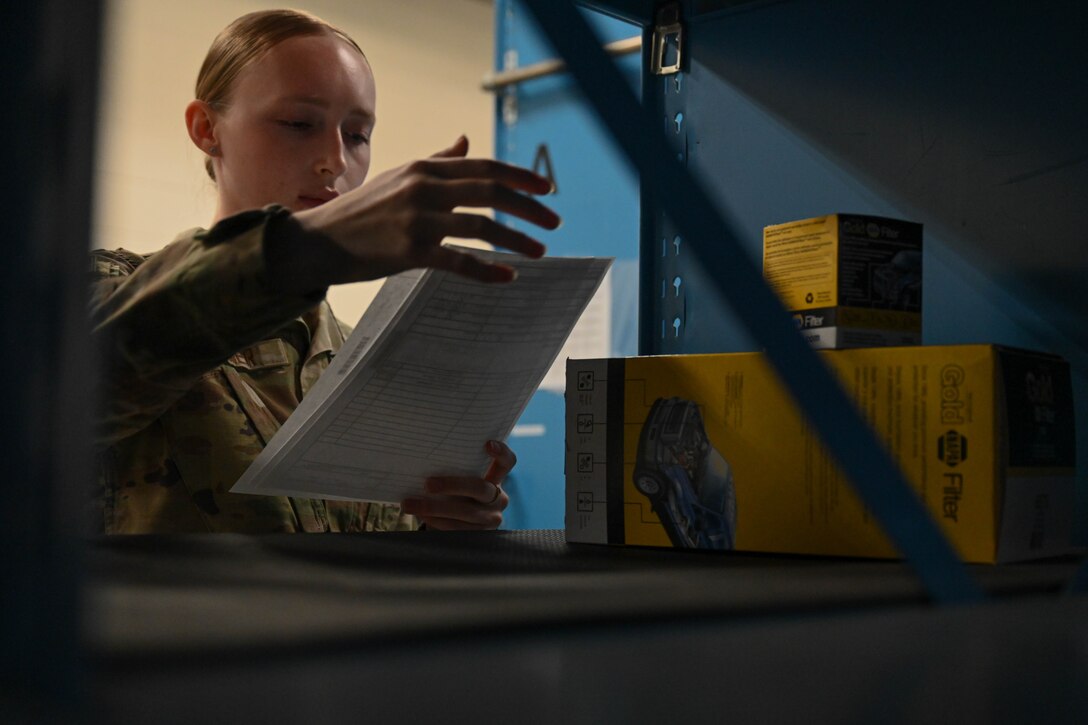 Airman 1st Class Alily Kliewer, 28th Logistics Readiness Squadron light ground vehicle fleet management and analysis technician, reviews a work order for a received maintenance part, Sept. 8, 2023, at Ellsworth Air Force Base, South Dakota.