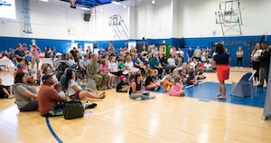 Military families gather during the Eustis Youth Book Bash in a basketball gym